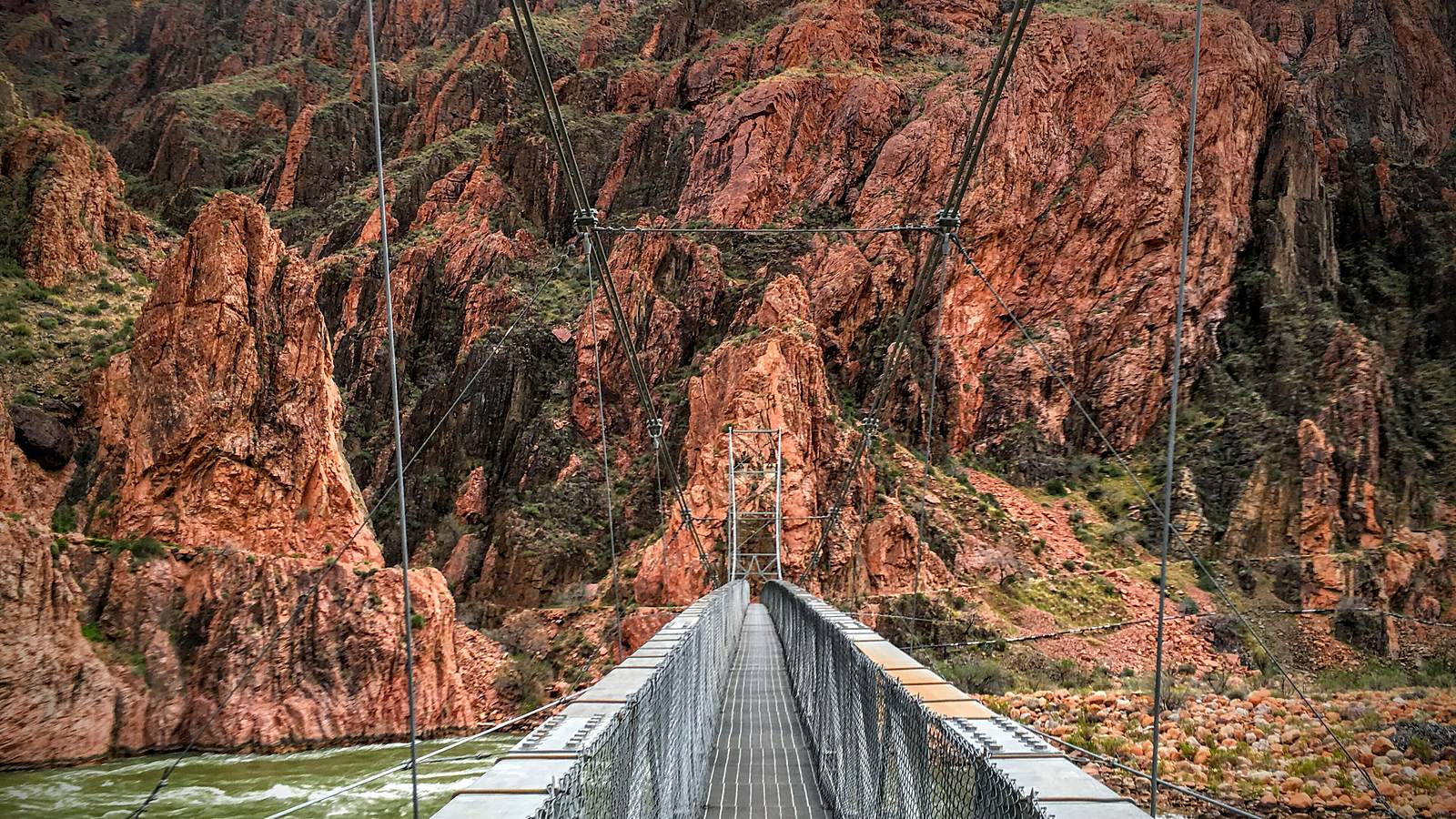 A flash flood at the bottom of the Grand Canyon killed one man and left 15 unaccounted for — and destroyed both of the only footbridges across the Colorado River